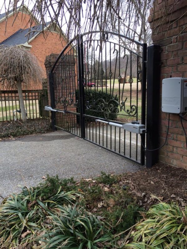 An automated gate with a custom ornamental design installed by Pro-Line Fence in Tennessee.