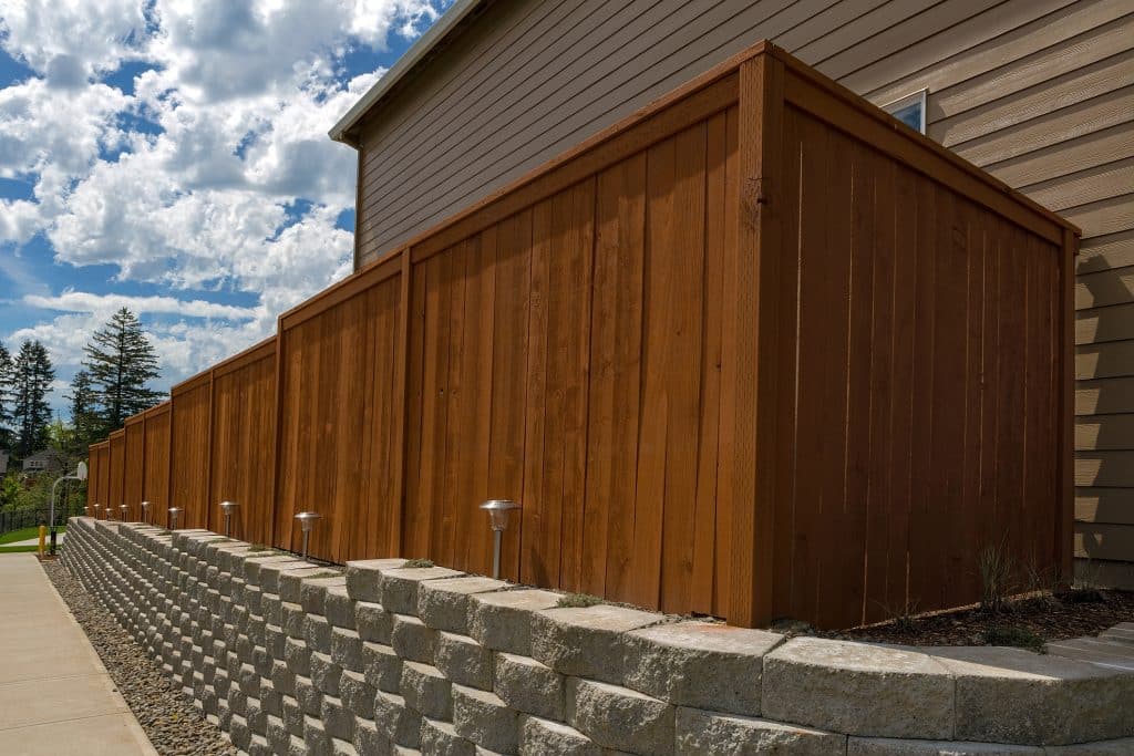 privacy fence in Belle Mead - Wood fence cement stack stone blocks retaining wall and landscaping lighting